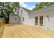 Newly constructed wooden back deck adjacent to a white home and backyard area at 6833 Evanston Ave, Indianapolis, IN 46220