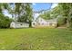 View of the home and backyard with back deck and detached garage at 6833 Evanston Ave, Indianapolis, IN 46220