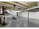 Unfinished basement area with painted walls, concrete floor, white stairs, and exposed ducts and pipes at 6833 Evanston Ave, Indianapolis, IN 46220