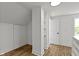 Light-filled bedroom featuring hardwood floors, a built-in shelf, and neutral walls at 6833 Evanston Ave, Indianapolis, IN 46220