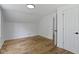 Bright bedroom featuring hardwood floors, neutral walls, and an open door at 6833 Evanston Ave, Indianapolis, IN 46220