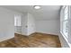 Bedroom featuring hardwood floors, a closet, neutral walls, and natural light at 6833 Evanston Ave, Indianapolis, IN 46220