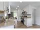 Updated kitchen with white cabinetry, stainless steel appliances, and sleek countertops at 6833 Evanston Ave, Indianapolis, IN 46220