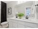 Modern bathroom featuring double sinks, elegant white cabinetry, and a large vanity mirror at 6842 Jacone Dr, Brownsburg, IN 46112
