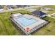 Aerial view of a community pool, featuring lounge chairs, umbrellas, and a covered pavilion at 6842 Jacone Dr, Brownsburg, IN 46112