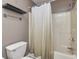 Practical bathroom showcasing a toilet and a shower tub with a neutral shower curtain at 6920 Wesley Ct, Indianapolis, IN 46220