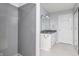 Bathroom featuring a shower and a double sink vanity with grey countertop at 6920 Wesley Ct, Indianapolis, IN 46220