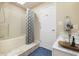 Cozy bathroom showcases a shower with a bathtub, and a modern vanity with marble countertop at 6920 Wesley Ct, Indianapolis, IN 46220