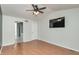 Bedroom with wood floors, ceiling fan, and ensuite bathroom at 6920 Wesley Ct, Indianapolis, IN 46220