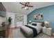 Cozy bedroom with blue accent wall, ceiling fan, area rug, and modern furnishings at 6920 Wesley Ct, Indianapolis, IN 46220
