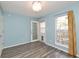 Bright bedroom features fresh paint, stylish flooring, and natural light from a window and door at 6920 Wesley Ct, Indianapolis, IN 46220