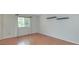 Bright bedroom features hardwood floors, neutral paint, and a window with natural light at 6920 Wesley Ct, Indianapolis, IN 46220