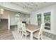 Bright dining room with hardwood floors, stylish lighting, and a backyard view at 6920 Wesley Ct, Indianapolis, IN 46220