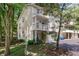 Attractive townhome with balcony, garage, and landscaping surrounded by mature trees at 6920 Wesley Ct, Indianapolis, IN 46220