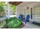 Charming covered front porch with seating, flowers and a 'welcome' sign at 6920 Wesley Ct, Indianapolis, IN 46220