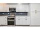 Chic kitchen with stainless steel appliances, modern white cabinets, and sleek countertops at 6920 Wesley Ct, Indianapolis, IN 46220