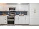 Chic kitchen with stainless steel appliances, modern white cabinets, and sleek countertops at 6920 Wesley Ct, Indianapolis, IN 46220
