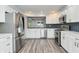 Modern kitchen design with stainless steel appliances, white cabinetry, and sleek countertops at 6920 Wesley Ct, Indianapolis, IN 46220