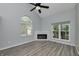Bright, airy living room featuring a fireplace, vaulted ceilings, and a big window at 6920 Wesley Ct, Indianapolis, IN 46220
