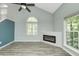 Bright living room featuring a fireplace, vaulted ceilings, and a big window at 6920 Wesley Ct, Indianapolis, IN 46220