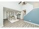 Open living room and dining area with hardwood floors, a kitchen bar, and a staircase at 6920 Wesley Ct, Indianapolis, IN 46220