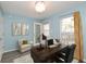 Home office with desk, chair, and decor boasts natural light from a window and door at 6920 Wesley Ct, Indianapolis, IN 46220