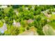 Aerial view of neighborhood, highlighting property and surrounding homes in wooded area at 7533 Deerfield Dr, Greenfield, IN 46140