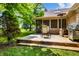 Outdoor deck for entertaining, complete with dining area, heater, and lush landscaping at 7533 Deerfield Dr, Greenfield, IN 46140
