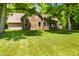 Well-maintained backyard with lush lawn, mature trees, and an inviting outdoor area at 7533 Deerfield Dr, Greenfield, IN 46140