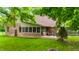 Charming backyard with mature landscaping, deck and patio area perfect for outdoor gatherings at 7533 Deerfield Dr, Greenfield, IN 46140