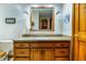 Bathroom featuring tiled floors, wood vanity, large mirror, and modern lighting at 7533 Deerfield Dr, Greenfield, IN 46140