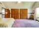 Bright bedroom boasts ample closet space, soft carpet, and a cozy rocking chair at 7533 Deerfield Dr, Greenfield, IN 46140