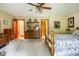 Bright bedroom featuring hardwood furniture, carpeted floors, and neutral-colored walls at 7533 Deerfield Dr, Greenfield, IN 46140