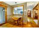 Breakfast nook featuring small wood table, hardwood floors, and view into the hallway at 7533 Deerfield Dr, Greenfield, IN 46140