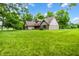 A lovely home with a well-kept lawn and mature trees creating a serene and private setting at 7533 Deerfield Dr, Greenfield, IN 46140