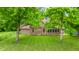 Home with brick facade and large windows overlooking a lush green lawn at 7533 Deerfield Dr, Greenfield, IN 46140