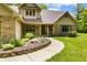 Inviting home with a welcoming front porch, charming brick accents, and a beautifully landscaped walkway at 7533 Deerfield Dr, Greenfield, IN 46140