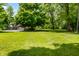 Spacious front yard with mature trees, providing ample shade and enhancing curb appeal at 7533 Deerfield Dr, Greenfield, IN 46140