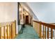 Well-lit hallway with wooden railings and unique decor at 7533 Deerfield Dr, Greenfield, IN 46140