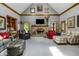 Spacious living room with a vaulted ceiling, brick fireplace, and comfortable seating arrangements at 7533 Deerfield Dr, Greenfield, IN 46140