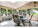 Inviting sunroom with large windows offering abundant natural light and scenic backyard views at 7533 Deerfield Dr, Greenfield, IN 46140