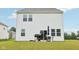 Backyard view of a white house with a grill, umbrella, patio, and grassy lawn at 7834 Hillway Dr, Camby, IN 46113
