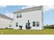 Backyard view of a home with white siding, a grassy lawn, an umbrella, and an outdoor table at 7834 Hillway Dr, Camby, IN 46113