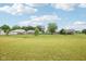Expansive grassy backyard view of various sheds and fences, bordered by lush green trees at 7834 Hillway Dr, Camby, IN 46113