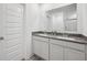 Bright bathroom featuring double sinks, gray countertop, and a large mirror at 7834 Hillway Dr, Camby, IN 46113