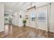 Open dining area with wood-look flooring, modern lighting, and ample natural light from the windows at 7834 Hillway Dr, Camby, IN 46113