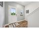 Light-filled entryway with wood-look flooring, a white front door, and a view of the outdoors at 7834 Hillway Dr, Camby, IN 46113