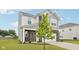 Two-story home with gray and white siding, brick accents, well-manicured lawn and landscaping at 7834 Hillway Dr, Camby, IN 46113