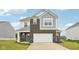 Two-story home featuring brick and gray siding, an attached two-car garage, and manicured lawn at 7834 Hillway Dr, Camby, IN 46113