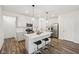 Well-lit kitchen with a spacious island, stainless steel appliances, white cabinets, and stylish pendant lighting at 7834 Hillway Dr, Camby, IN 46113
